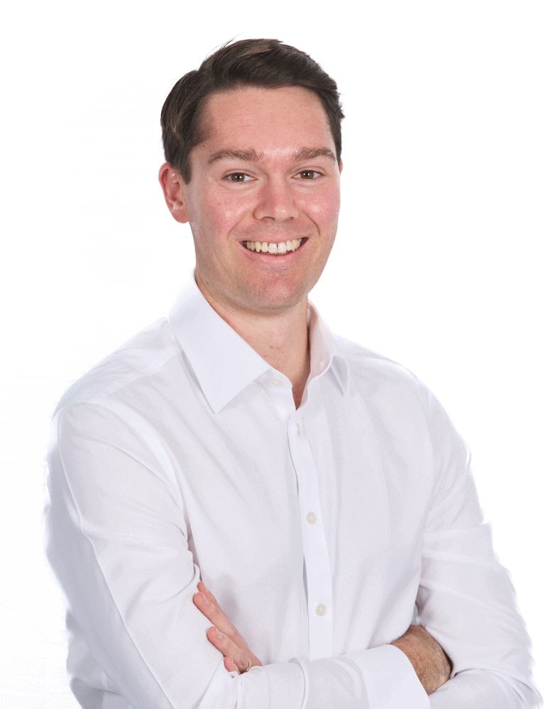 Close-up of a smiling man in a white shirt with crossed arms, professional headshot for corporate or business profile.