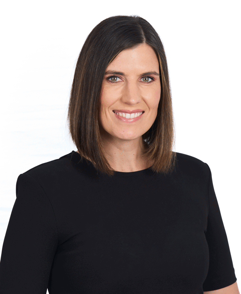 Professional woman with shoulder-length brown hair smiling, wearing a black top, isolated on white background, representing business, leadership, and confidence.