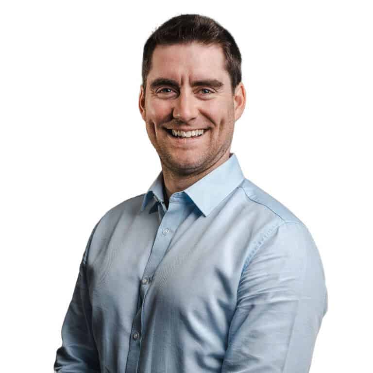 Male professional smiling in a light blue dress shirt, representing leadership and confidence for CMEWA.