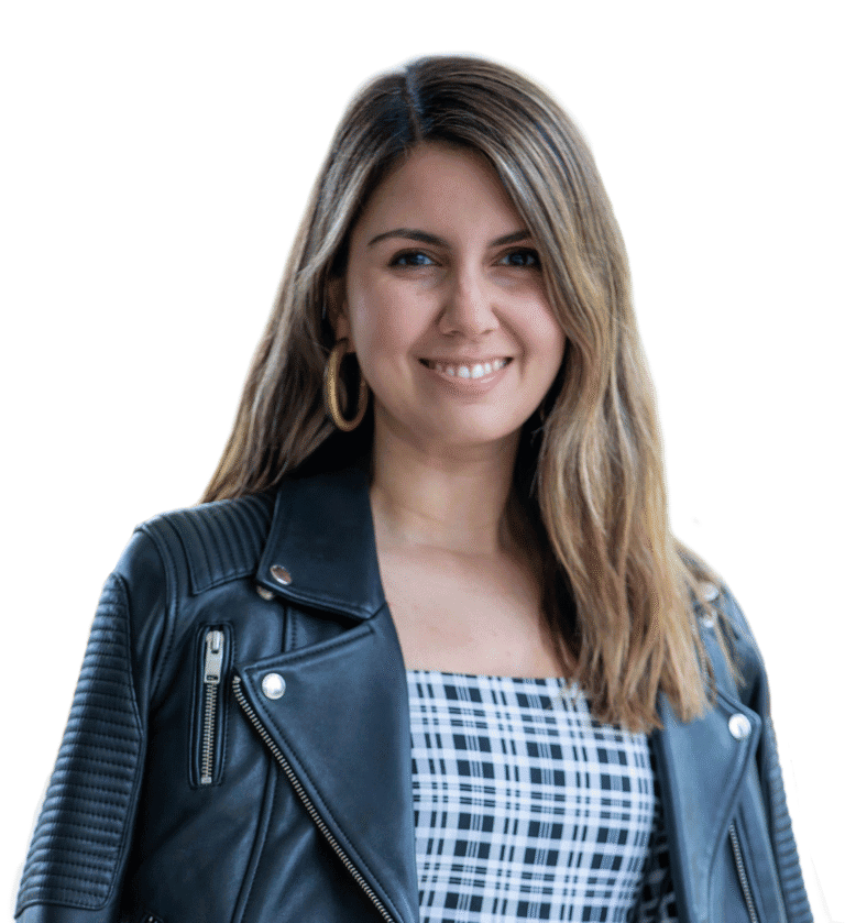 Smiling woman with long brown hair wearing a black leather jacket and checkered top, promoting professional confidence and style for CMEWA.