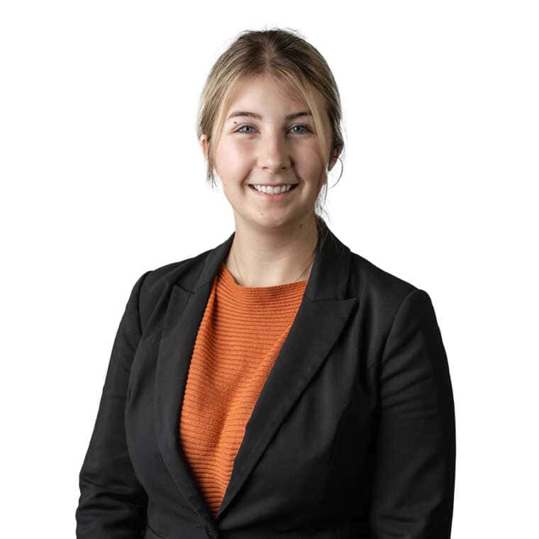 Young professional woman smiling in business attire for CMEWA, representing confidence and professionalism.