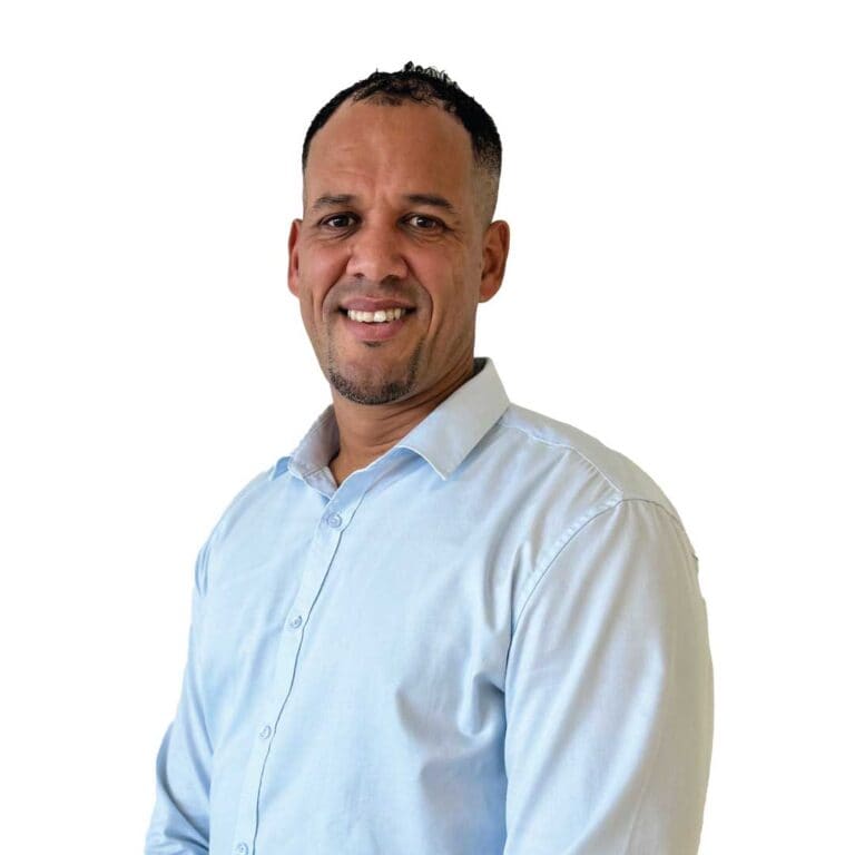 Portrait of a smiling man in a white dress shirt, professional headshot for business or corporate use, emphasizing confidence and approachability for corporate photography and professional branding.